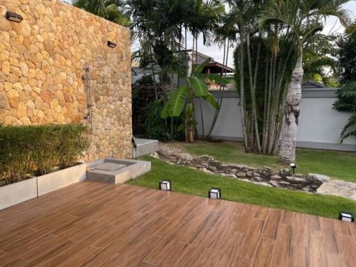 Outdoor patio with stone wall and garden