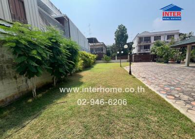 Garden with greenery, lawn, and surrounding buildings