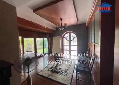 Spacious living room with wooden flooring and decorative ceiling