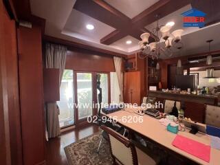 Elegant dining room with wooden accents and ample natural light