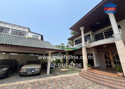 Exterior view of a residential property with a carport and driveway