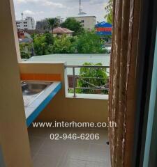 Balcony with a sink and view of surrounding buildings