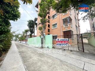 Apartment building with a gated entrance and a street view