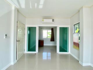 Bright living room with modern interior style featuring large windows and air conditioning.