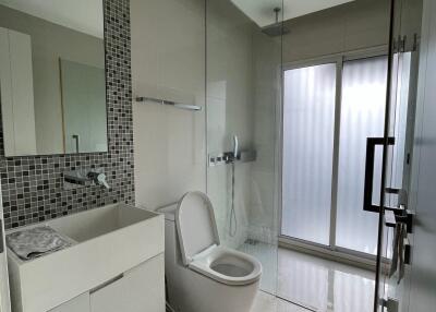 Modern bathroom with glass shower and large vanity mirror