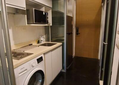 Compact kitchen with modern appliances and washer