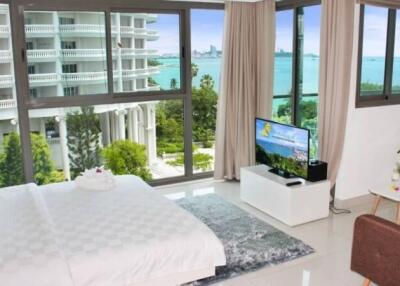 Bedroom with large windows and ocean view