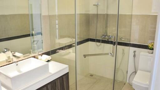 Modern bathroom with glass shower enclosure and white basin