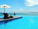 Infinity pool with lounge chairs and ocean view