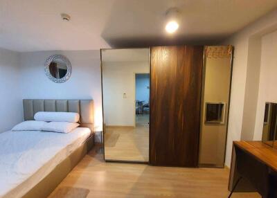 Spacious bedroom with a bed, wardrobe, and a mirror