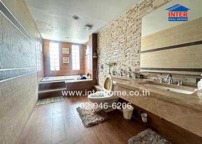 Spacious bathroom with modern fixtures and a bathtub.