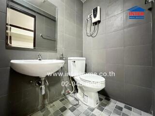 Modern bathroom with sink, toilet, and water heater