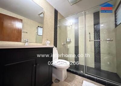 Modern bathroom with glass shower and dark wood vanity