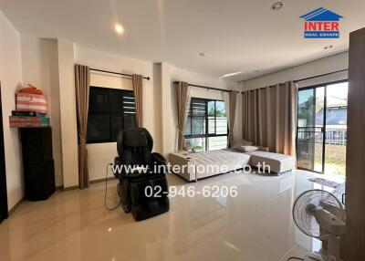 Spacious and bright living area with large windows and tiled flooring