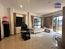 Spacious and bright living area with large windows and tiled flooring