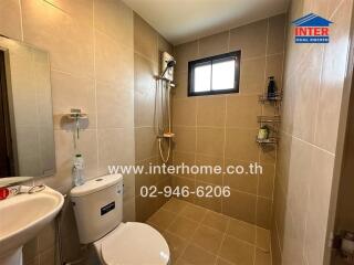 Modern bathroom with beige tiles and shower