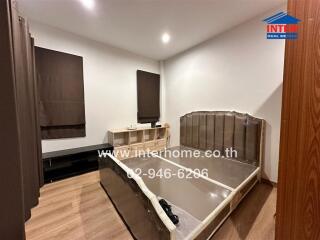 Modern bedroom with wooden floor and partially furnished