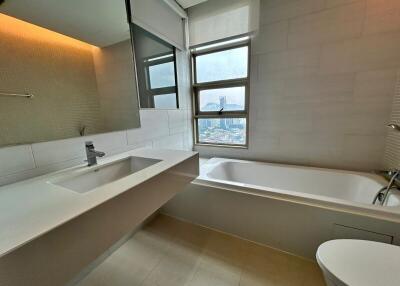 Modern bathroom with sink, bathtub, and window