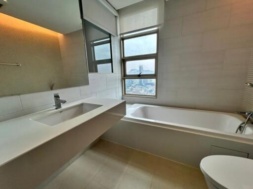 Modern bathroom with sink, bathtub, and window