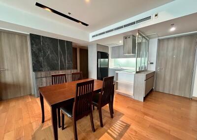 Modern dining area adjacent to a sleek kitchen