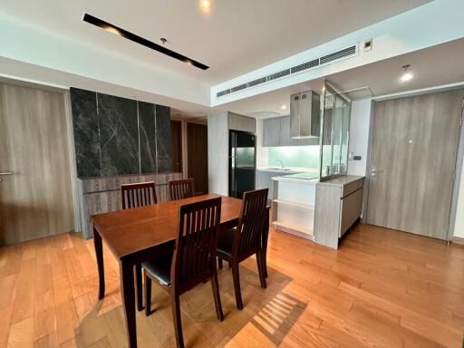 Modern dining area adjacent to a sleek kitchen