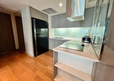 A modern kitchen with wooden flooring and built-in appliances