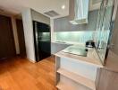 A modern kitchen with wooden flooring and built-in appliances