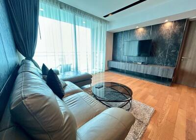 Modern living room with leather sofa and wall-mounted TV