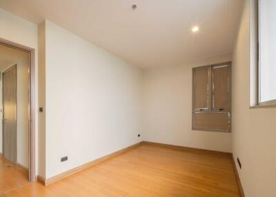Unfurnished bedroom with wooden flooring and large windows