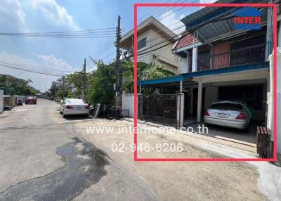 Exterior of a residential building with a garage and parked cars