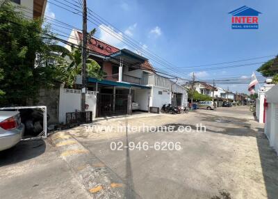 Street view of neighborhood with houses and parked vehicles