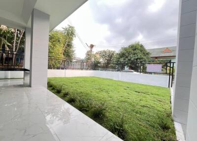 Covered patio area with view of large green lawn