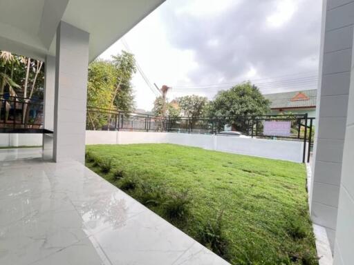 Covered patio area with view of large green lawn