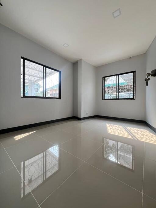 Spacious empty bedroom with large windows