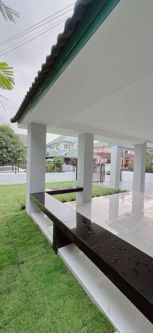 Covered patio area with tiled floor and open view of neighborhood