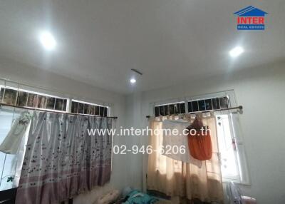 Bedroom with windows, curtains, and lights