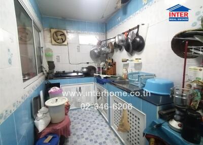 Compact kitchen with cooking utensils and storage