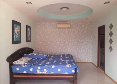 Well-furnished bedroom with a double bed and wall-mounted air conditioner