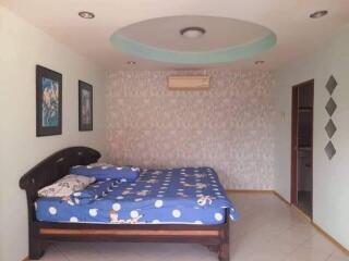 Well-furnished bedroom with a double bed and wall-mounted air conditioner