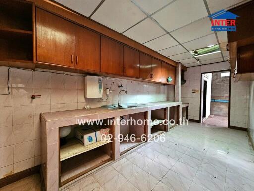 Spacious kitchen with wooden cabinets and tiled backsplash