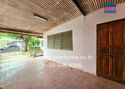 Covered outdoor area with tiled flooring and wooden ceiling