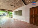 Covered outdoor area with tiled flooring and wooden ceiling