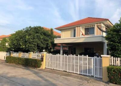 Two-story house with a white picket fence