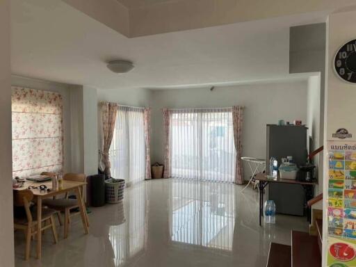 Spacious main living area with dining table and large windows