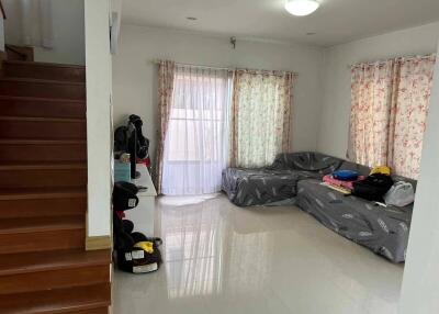 Living room with staircase and cozy sofa area