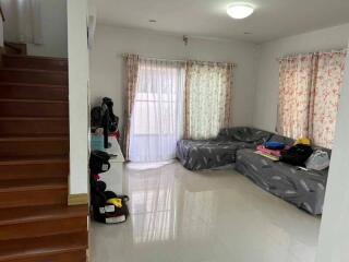 Living room with staircase and cozy sofa area