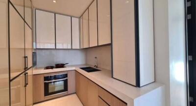 Modern kitchen with built-in appliances and wooden cabinetry