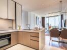 Modern kitchen and dining area with large windows and city view