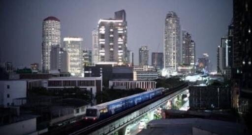 Cityscape with tall buildings and a train passing by