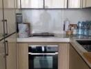 Modern kitchen with light-colored cabinets and stainless steel appliances